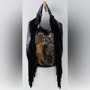 Free People Eye of the Tiger bag. Only used once. Stored in dust bag. Like new.